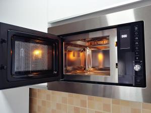 a microwave oven with its door open in a kitchen at Lux Studio Apartment Vidanovic in Pirot