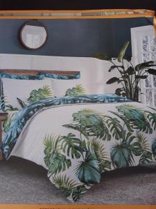 a bed with a comforter with plants on it at Apartments Paris in Umag