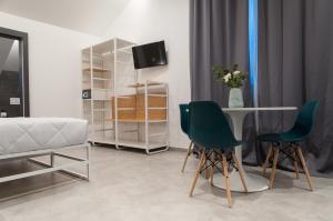 Televízia a/alebo spoločenská miestnosť v ubytovaní Residence Hotel Moderno