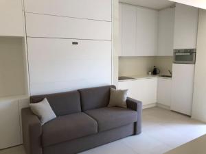 a living room with a couch and a kitchen at Olivo House 1 in Portovenere