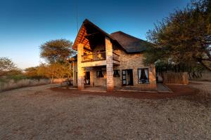 an old brick house on a gravel road at Makhato Bush Lodge 111 in Bela-Bela