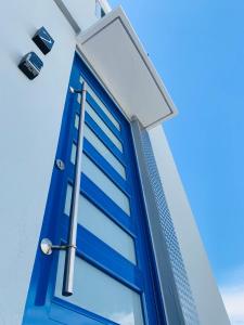 a blue window on a building with a street light at Modern Suite #2 Pasavento in Aguadilla