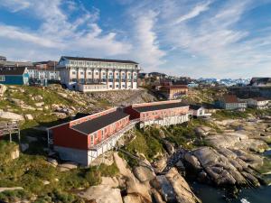 a town on a rocky hill with a train station at Hotel Hvide Falk in Ilulissat