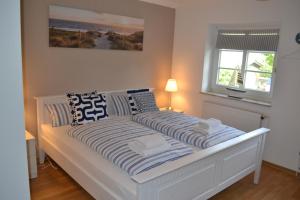 Cama ou camas em um quarto em Dat Strandgood
