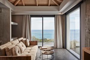 a living room with a couch and a large window at Villa Mare in Skala