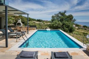 a swimming pool with a view of the ocean at Villa Blue Sea in Skala