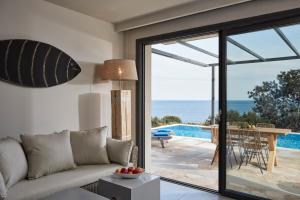 a living room with a couch and a view of the ocean at Villa Blue Sea in Skala +11 photos