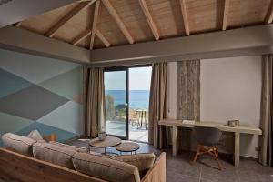 a living room with a couch and a view of the ocean at Villa Blue Sea in Skala