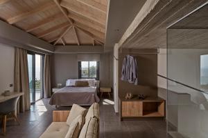 a bedroom with a bed and a glass wall at Villa Blue Sea in Skala