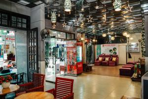 a restaurant with chairs and tables in a room at DMZ Hostel in Hue