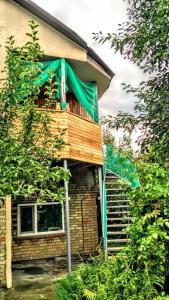 a house with a green tarp on the side of it at Гостевой таунхаус in Demidov