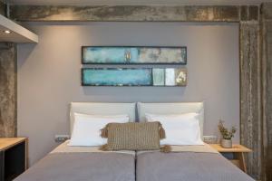 a bedroom with a bed with two pillows at Villa Sea front in Skala