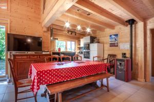 cocina y comedor con mesa roja y sillas en La Griotte, en Morzine