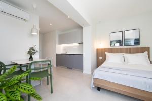 a bedroom with a bed and a table and a kitchen at Apartments No 18 in Tučepi