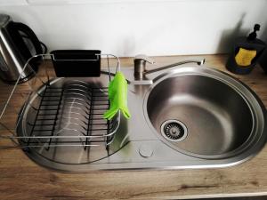a kitchen sink with a green frog hanging from it at Les Insolites de Champeix in Champeix +35 photos