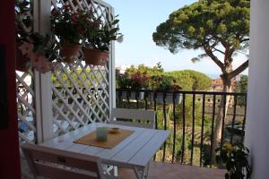 a white table and chairs on a balcony with a view at BLU SEA SORRENTO in Sorrento