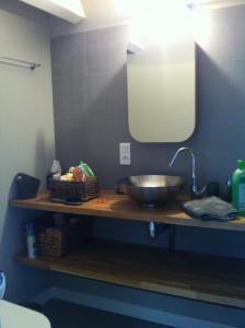 a bowl on a counter with a sink in a bathroom at Le Gite de Fanny in Saintes-Maries-de-la-Mer