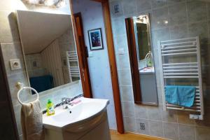a bathroom with a sink and a shower with a mirror at la petite fontaine in Écuras +13 photos