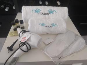 a white hair dryer and towels on a table at Tassos 2 in Pefkochori