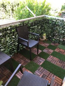 a chair sitting on a patio in front of a hedge at B&B IL CAVALIERE in Baronissi