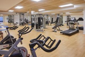 a gym with a lot of treadmills and machines at Hotel Torre del Mar - Ibiza in Playa d'en Bossa