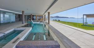a swimming pool in a house with a view of the water at Hotel Torre del Mar - Ibiza in Playa d'en Bossa