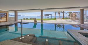 a swimming pool with a view of the ocean at Hotel Torre del Mar - Ibiza in Playa d'en Bossa