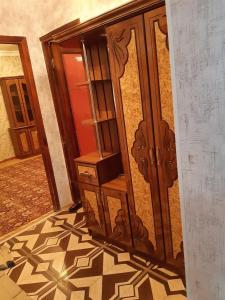 a wooden door in a room with a tile floor at SPARTA Apartment Complex in Sevan