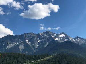 a view of a mountain range with a ski lift at The Hitching Post Motel in Pemberton