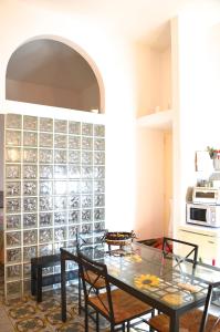 a dining room with a glass wall at Belvedere Piano di Sorrento in Piano di Sorrento