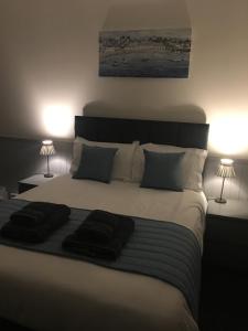 A bed or beds in a room at The Prince Guest House 