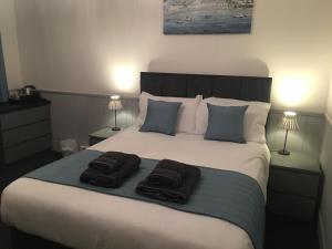 A bed or beds in a room at The Prince Guest House 