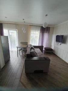 a living room with a couch and a table at Апартаменти Лесі Українки, Замок in Luts'k