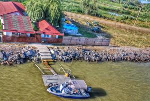 a group of boats in the water next to a house at La Nea Paul in Maliuc