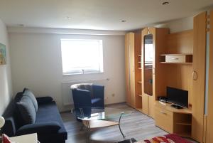 a living room with a couch and a glass table at Ferienwohnung Rixen in Dargelin