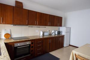 a kitchen with wooden cabinets and a counter top at Casa do Sr. Paulo in Nordeste