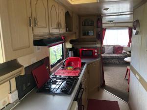 a kitchen with a stove top oven in an rv at i15 The Chase in Ingoldmells