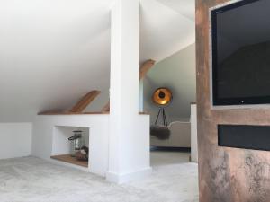 a living room with a tv on a wall at Ferienhaus am See in Wesenberg