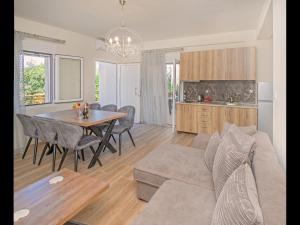 a living room with a couch and a table and a kitchen at Pasithea House in Skala Sotiros