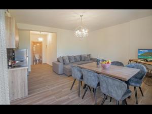 a kitchen and living room with a table and a couch at Pasithea House in Skala Sotiros