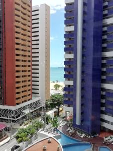 a view of the beach from the balcony of a building at Beach Class Rosalux 707 in Fortaleza