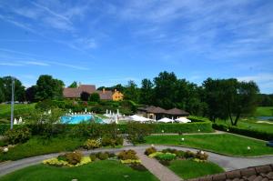 an aerial view of a resort with a swimming pool at Golf Hotel Castelconturbia in Agrate Conturbia