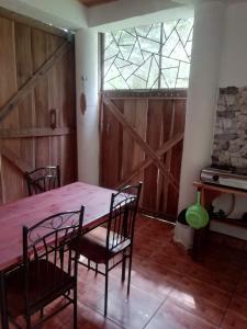 a dining room with a table and chairs and a window at Caribbean Secret in Cahuita