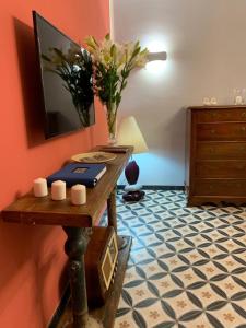 a room with a table with a vase of flowers on it at Jeans Luxury House in Genova