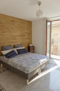una camera con un grande letto con testiera in legno di Corte Soriano a Montenero di Bisaccia