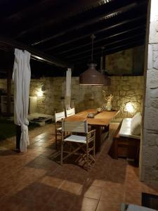 a dining room with a wooden table and chairs at Cozy Cliff House in Nea Potidaea