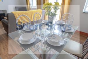 a glass table with plates and dishes on it at Cottage Hill in Newport