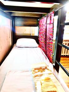 a small bed in a room with at Hostel Imona in Samarkand