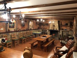 a dining room with a table and chairs and a fireplace at Casa Rural "Rincón del Edén" in Tardobispo