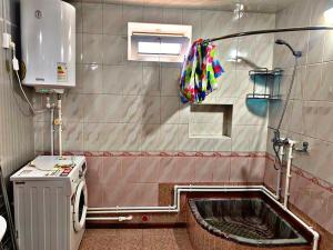 a small bathroom with a shower and a sink at Hostel Imona in Samarkand +12 photos